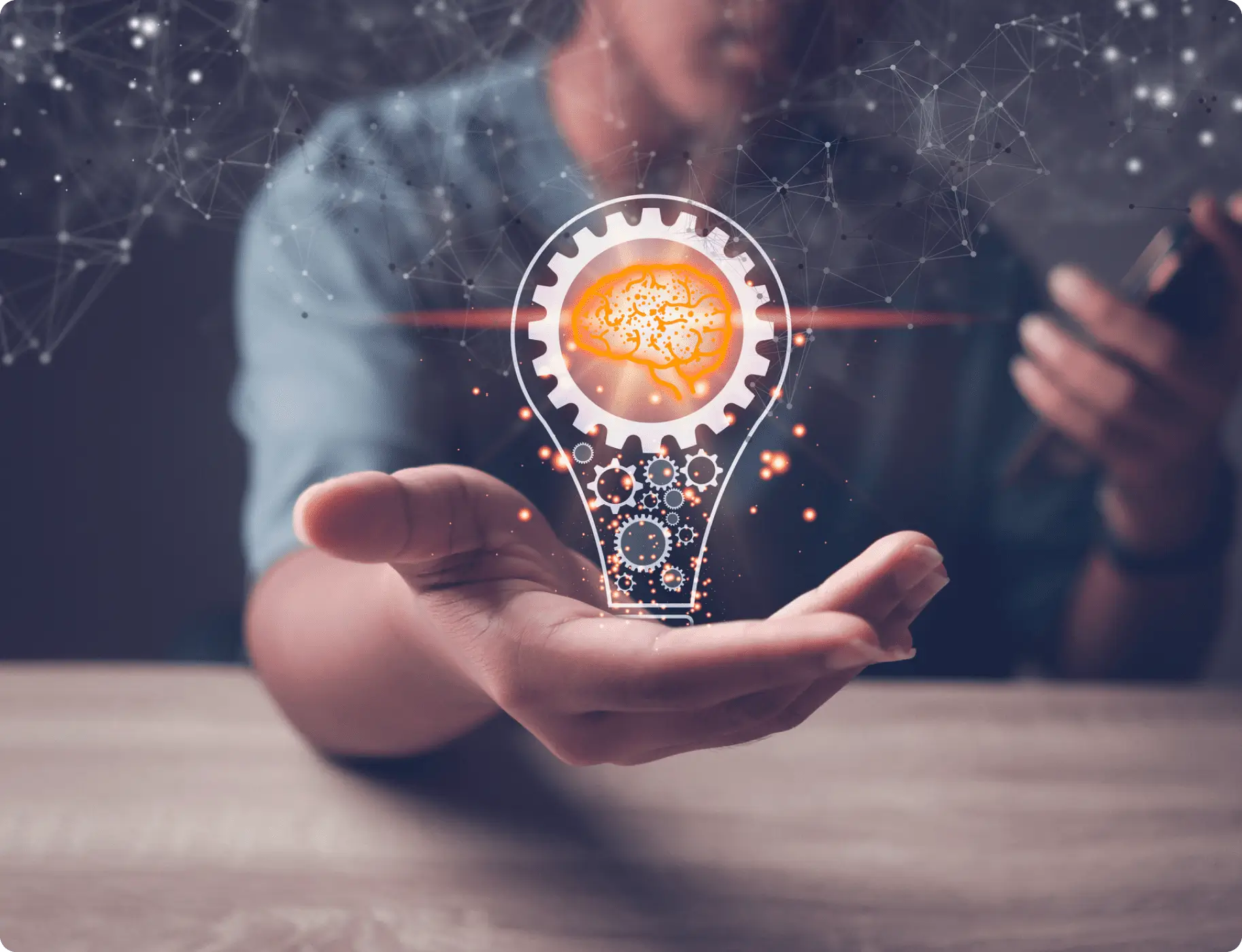 GettyImages-1445112458 A man holding out his hand with an image of a light bulb.