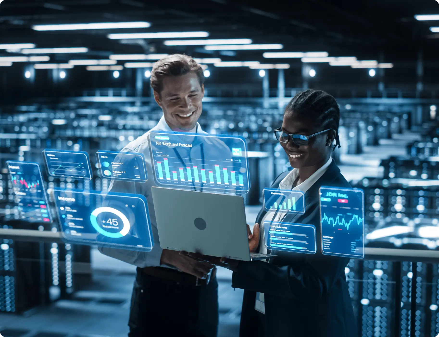 GettyImages-1461628067 Two people are standing in a warehouse with a laptop.
